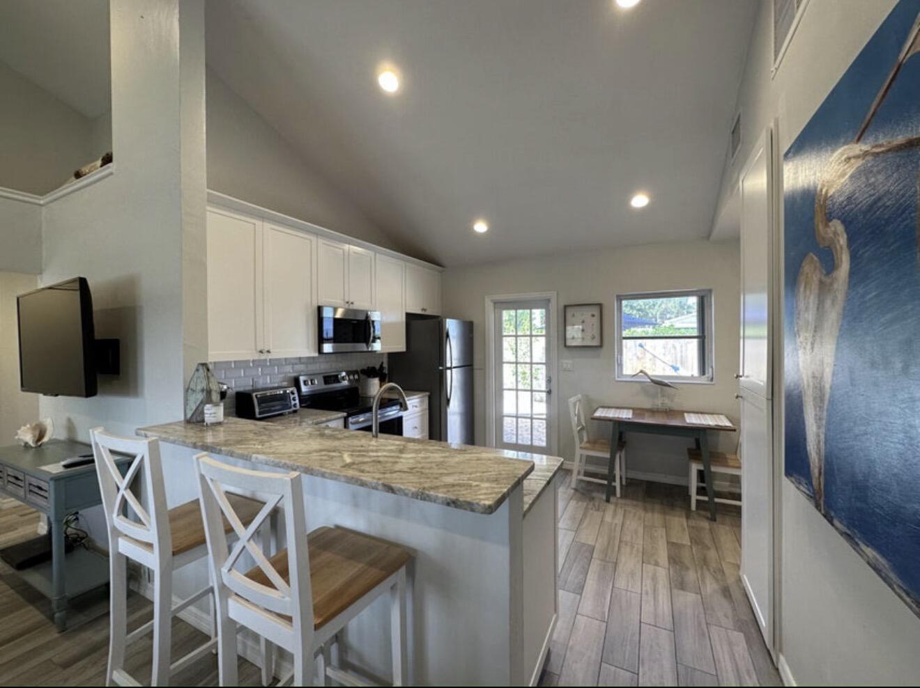 49 Douglas Drive Ocean Ridge, FL 33435 - Photo 19 of 65 a view of a dining room with furniture window and wooden floor