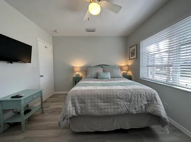 a bedroom with a bed and a tv