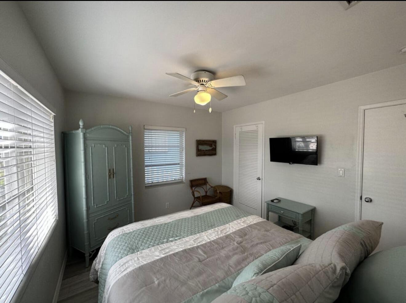 49 Douglas Drive Ocean Ridge, FL 33435 - Photo 32 of 65 a bedroom with a bed a flat screen tv and a window
