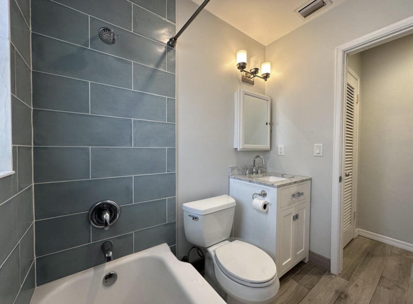 49 Douglas Drive Ocean Ridge, FL 33435 - Photo 39 of 65 a bathroom with a sink a toilet and a mirror