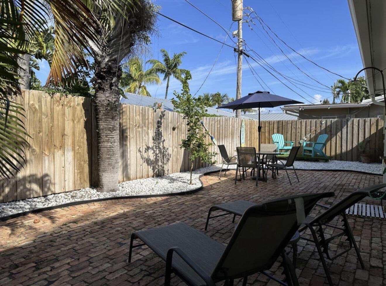 49 Douglas Drive Ocean Ridge, FL 33435 - Photo 43 of 65 a view of a patio with table and chairs and potted plants