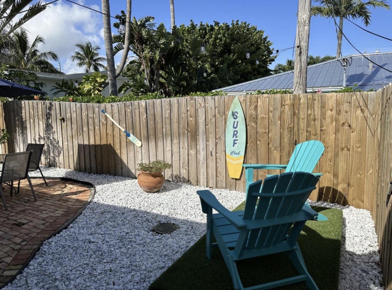 49 Douglas Drive Ocean Ridge, FL 33435 - Photo 46 of 65 a backyard of a house with table and chairs