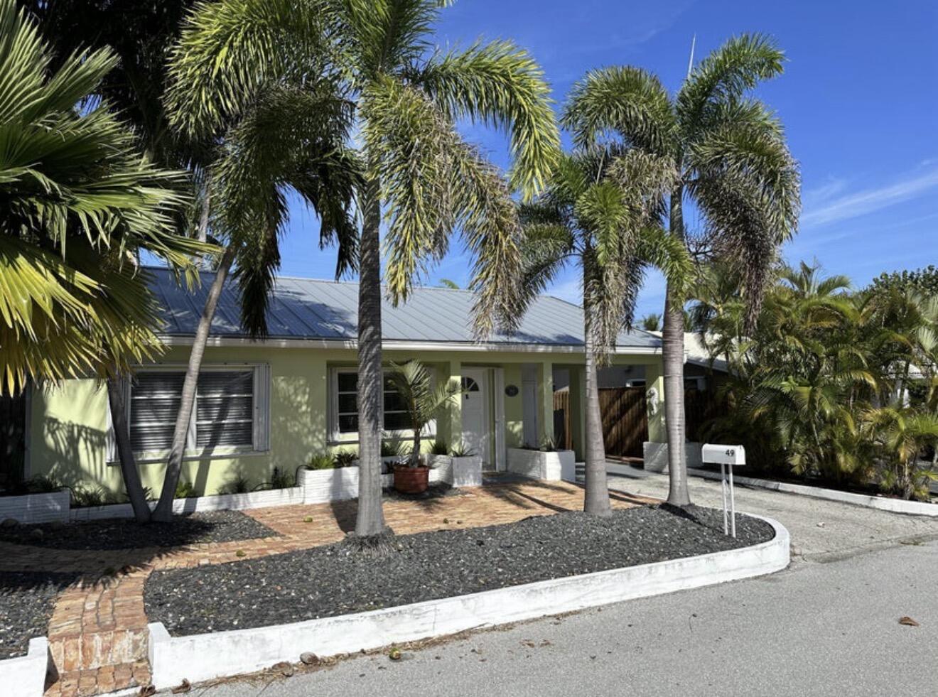49 Douglas Drive Ocean Ridge, FL 33435 - Photo 5 of 65 a front view of a house with tree s
