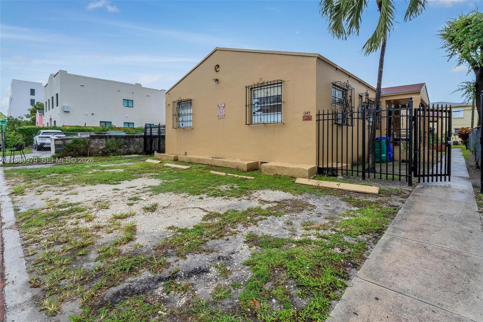 1345 Southwest 7th Street Miami, FL 33135 - Photo 5 of 37 a backyard of a house with barbeque oven and palm trees