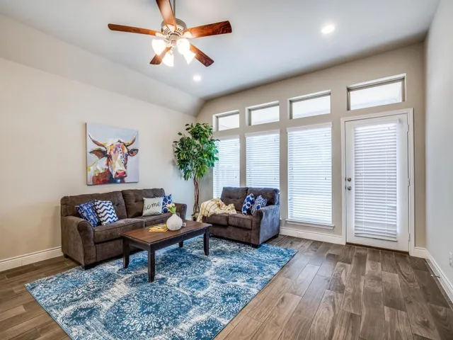 a living room with furniture and a large window