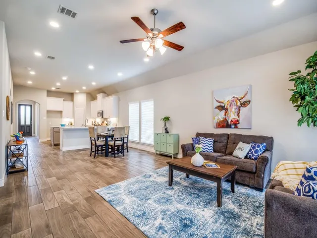 a living room with furniture and kitchen view