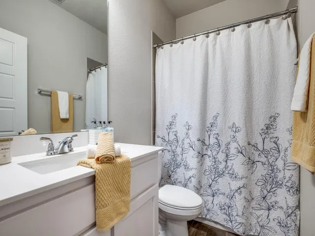 a bathroom with a sink toilet and shower