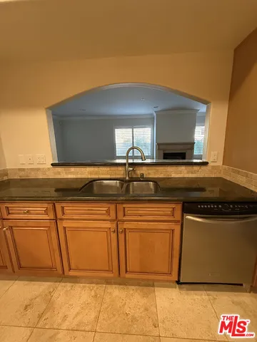 a kitchen with stainless steel appliances granite countertop a sink and cabinets