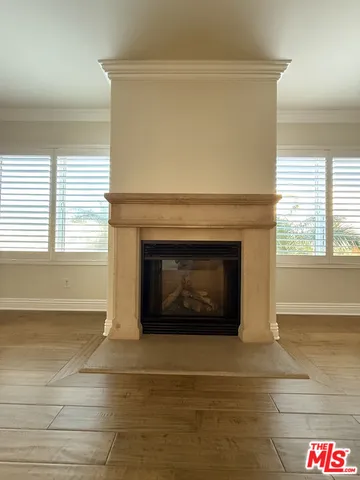 a living room with a fireplace and a table