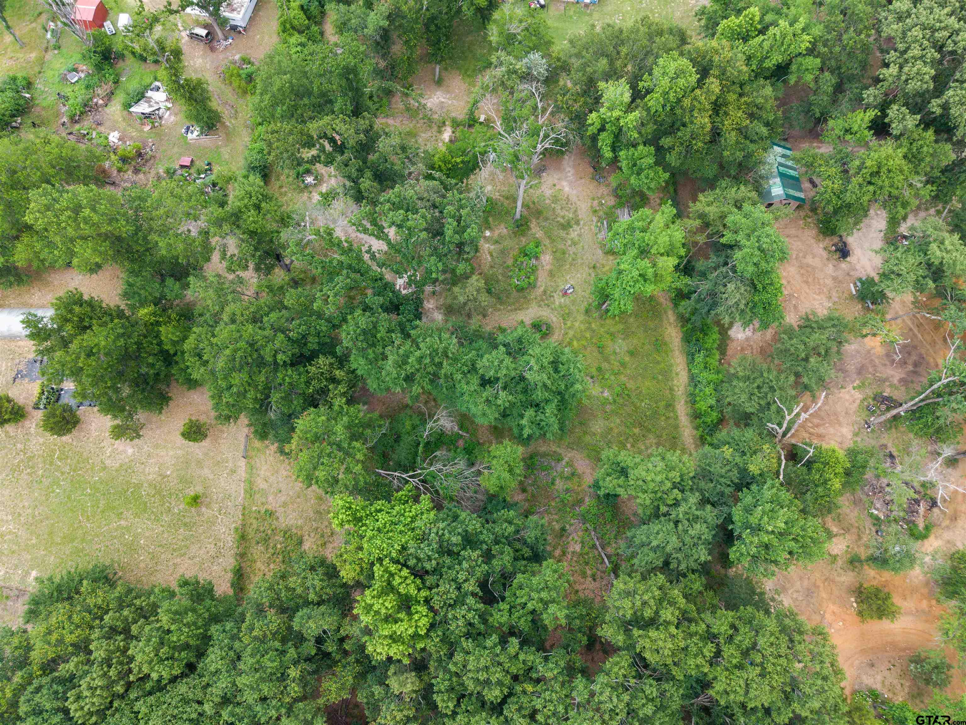 2425 Thompson Lane Tyler, TX 75704 - Photo 27 of 27 an aerial view of residential house with outdoor space and trees all around