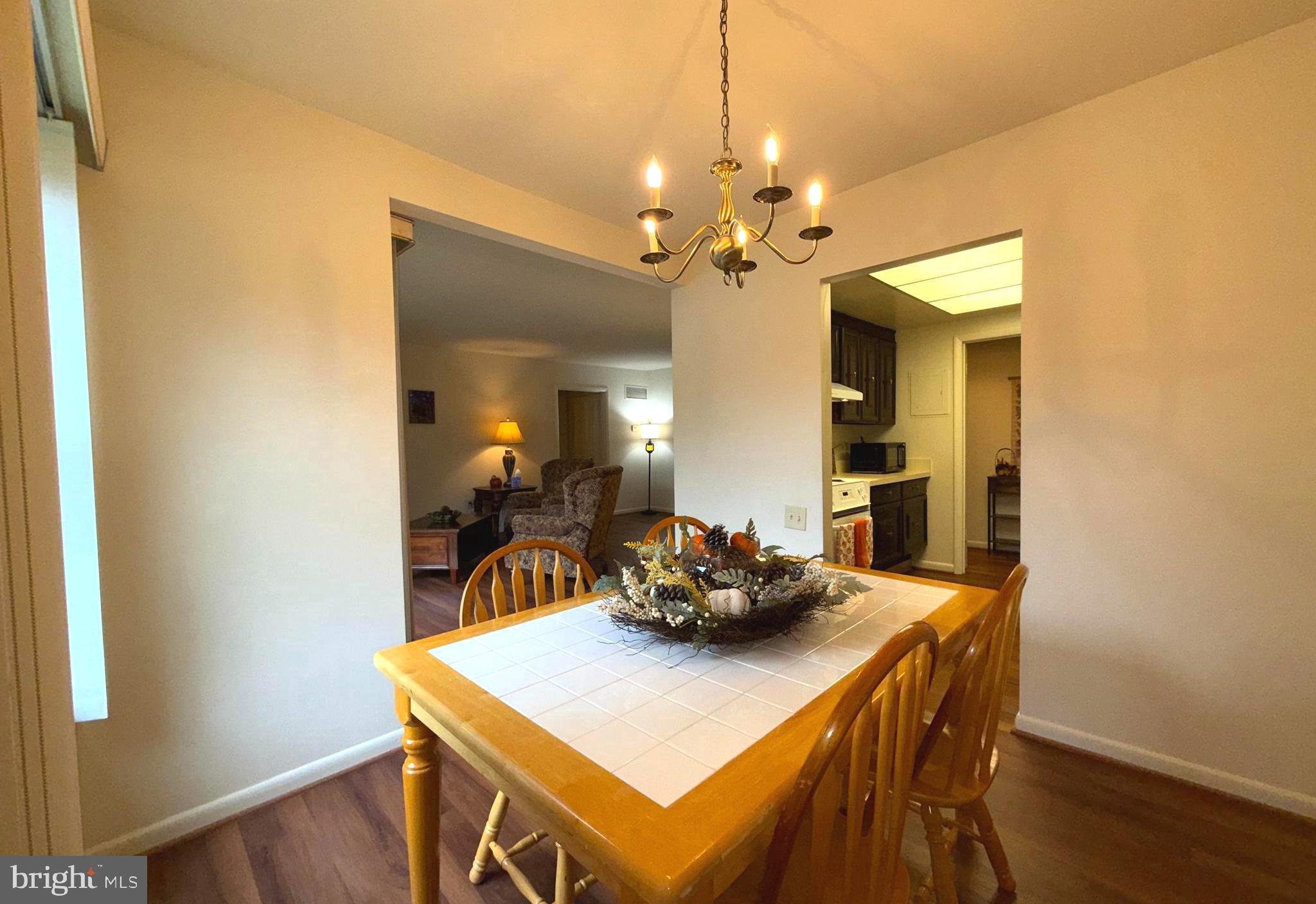 3352 Chiswick Court, Unit 572E Silver Spring, MD 20906 - Photo 15 of 41 a view of a dining room with furniture and wooden floor
