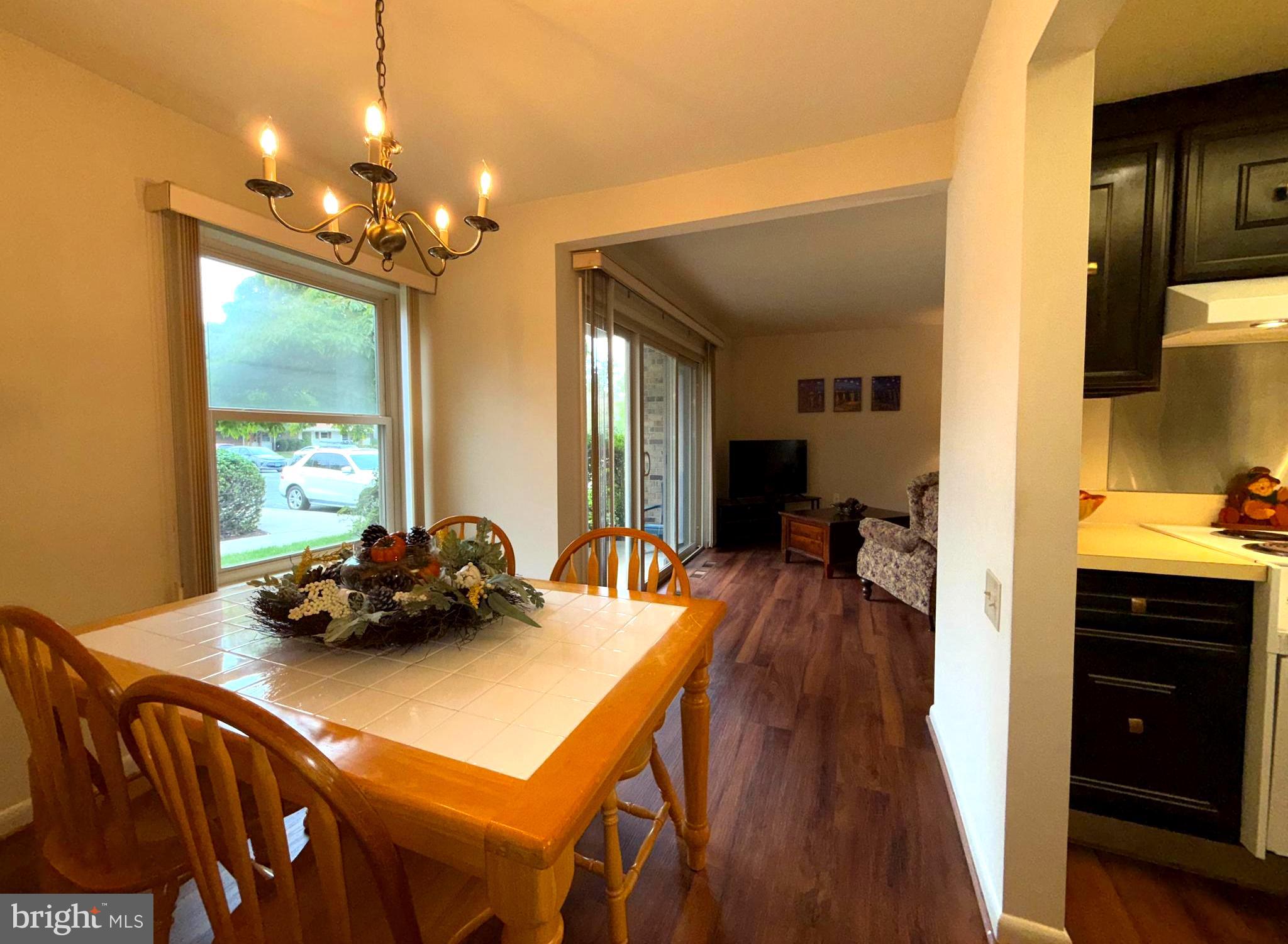 3352 Chiswick Court, Unit 572E Silver Spring, MD 20906 - Photo 18 of 41 a dinning room with furniture and a chandelier