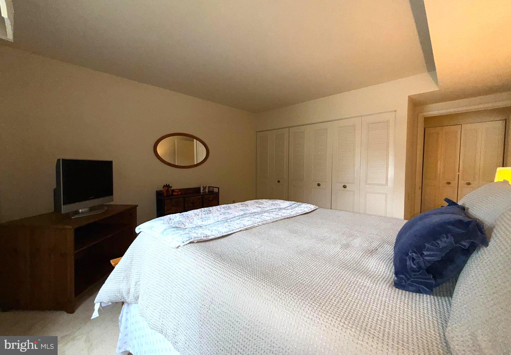 3352 Chiswick Court, Unit 572E Silver Spring, MD 20906 - Photo 22 of 41 a bedroom with a bed and a flat screen tv