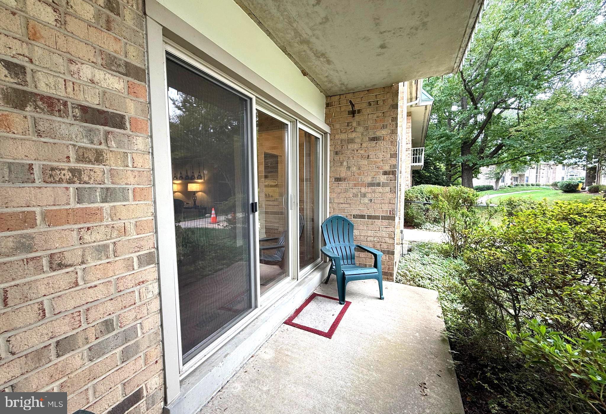 3352 Chiswick Court, Unit 572E Silver Spring, MD 20906 - Photo 26 of 41 a view of porch with a bench and chair