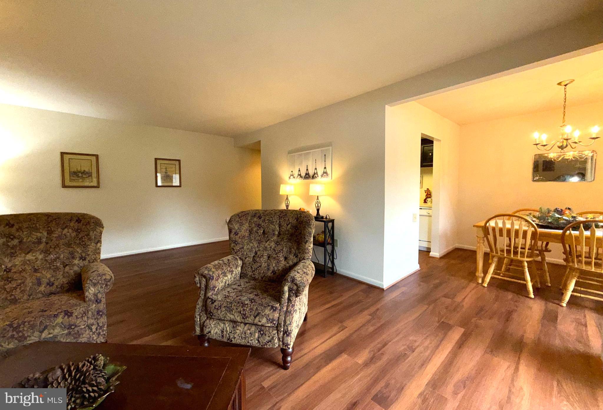 3352 Chiswick Court, Unit 572E Silver Spring, MD 20906 - Photo 3 of 41 a living room with furniture wooden floor and a dining table