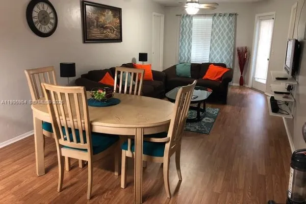 a view of a dining room with furniture wooden floor and a chandelier