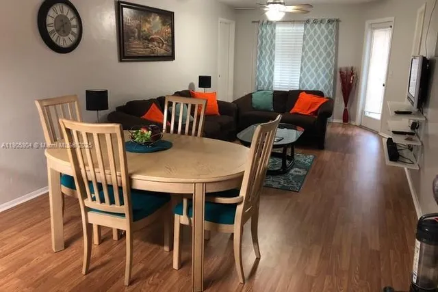 a view of a dining room with furniture wooden floor and a chandelier