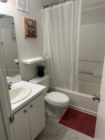a bathroom with a toilet a sink and bathtub
