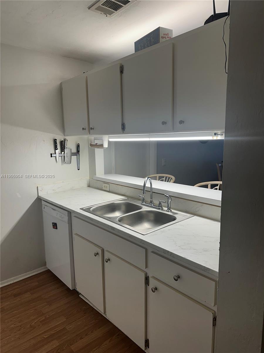 4000 Southwest 23rd Street, Unit 2301 Gainesville, FL 32608 - Photo 5 of 19 a kitchen with a sink and wooden cabinets