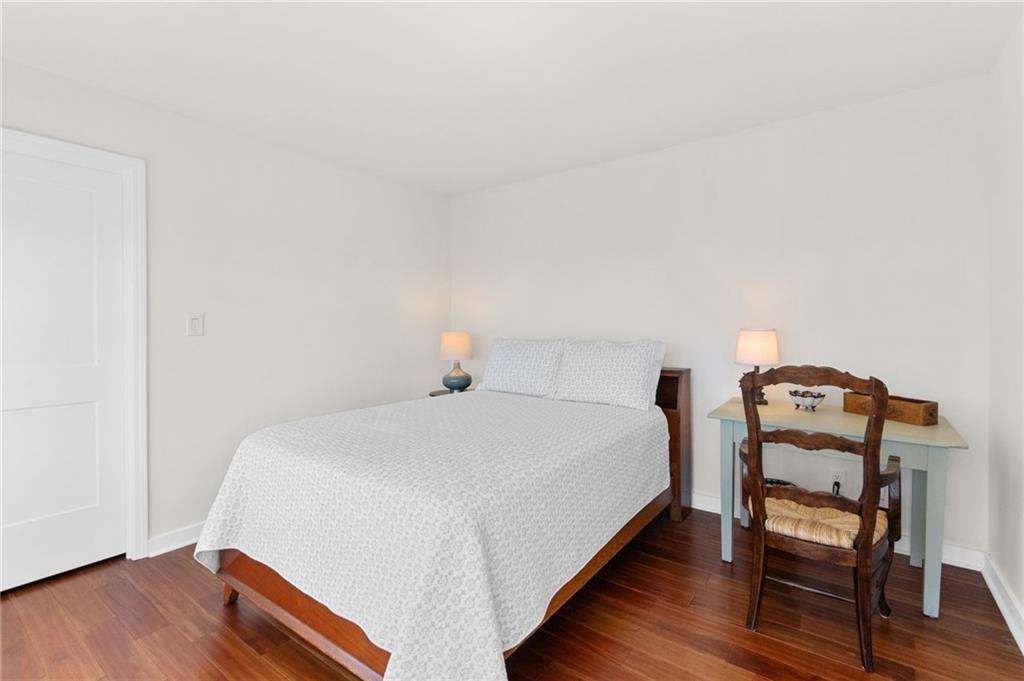 295 Starcross Lane Jasper, GA 30143 - Photo 25 of 65 a bedroom with a bed a table and wooden floor