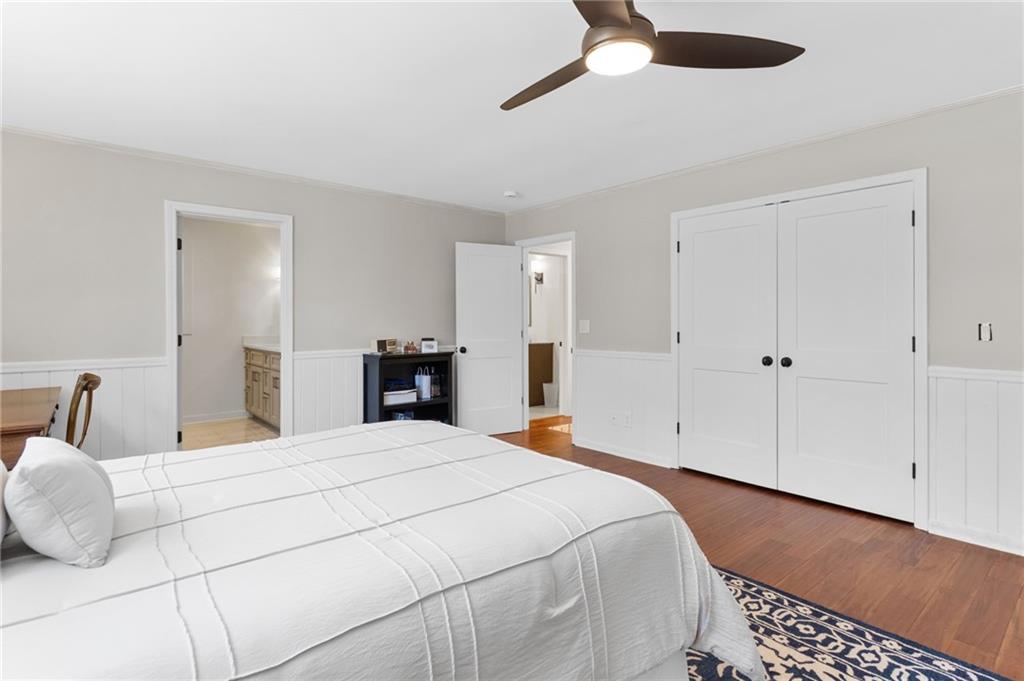 295 Starcross Lane Jasper, GA 30143 - Photo 28 of 65 a large bedroom with a bed and a chandelier