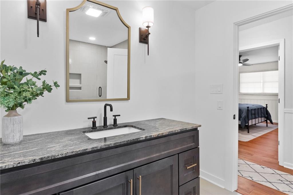 295 Starcross Lane Jasper, GA 30143 - Photo 33 of 65 a bathroom with a granite countertop sink and a mirror