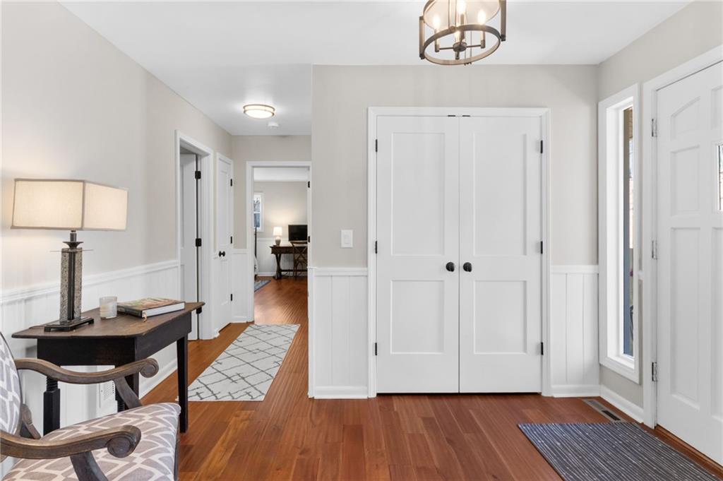 295 Starcross Lane Jasper, GA 30143 - Photo 6 of 65 a view of a hallway with wooden floor and a bathroom