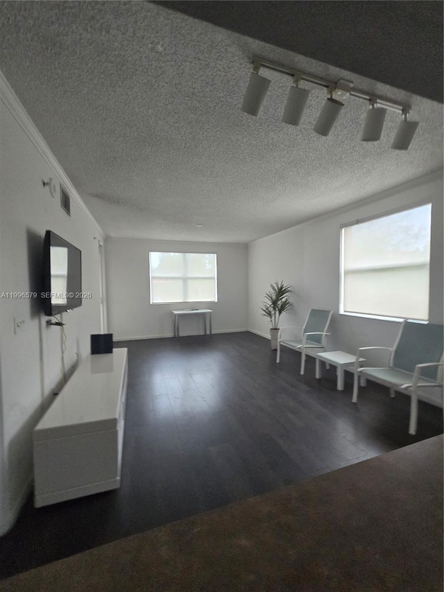 17150 North Bay Road, Unit 2316 Sunny Isles Beach, FL 33160 - Photo 2 of 9 a view of a livingroom with furniture hardwood floor and a flat screen tv