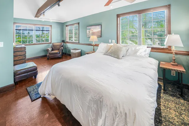 a spacious bedroom with a bed and a large window