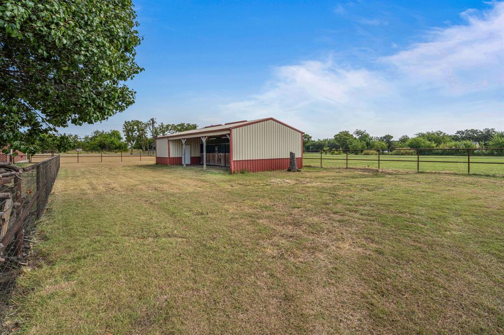 6501 Indian Trail Sanger, TX 76266 - Photo 34 of 39 View of yard with an outdoor structure, an outbuilding, and a view of countryside