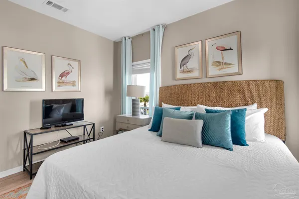 a bedroom with a large bed and a tv