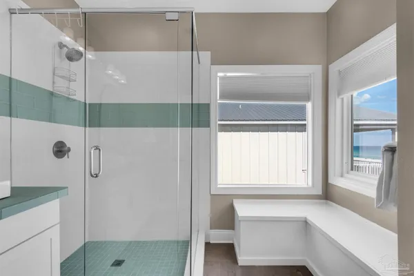 a bathroom with a shower and a window