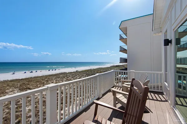 a view of balcony with wooden floor and seating space