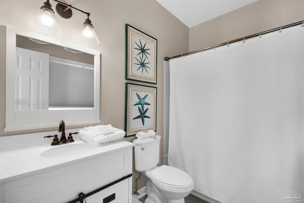 a bathroom with a sink a toilet and mirror