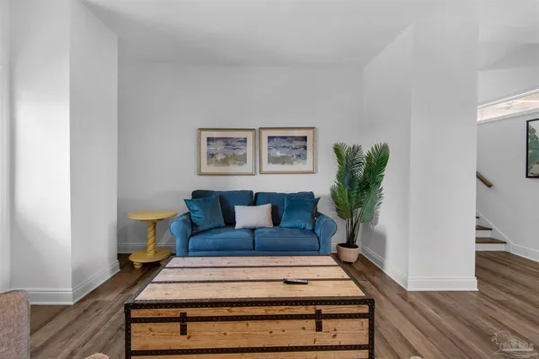 a living room with furniture and a potted plant