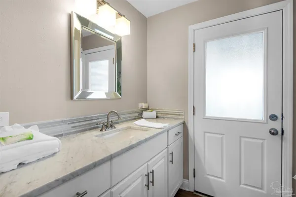 a bathroom with a sink a vanity and a mirror