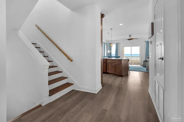 a view of a kitchen with wooden floor and windows