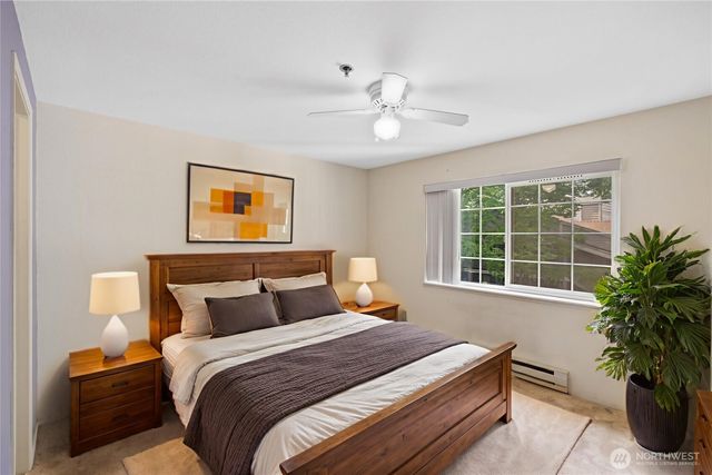 a bedroom with a large bed and a potted plant