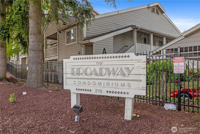 a view of a house with a yard and potted plants