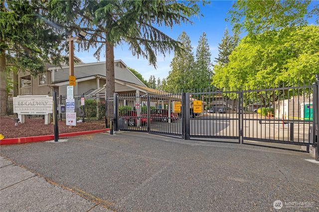 a view of a street with a cars park side of a road