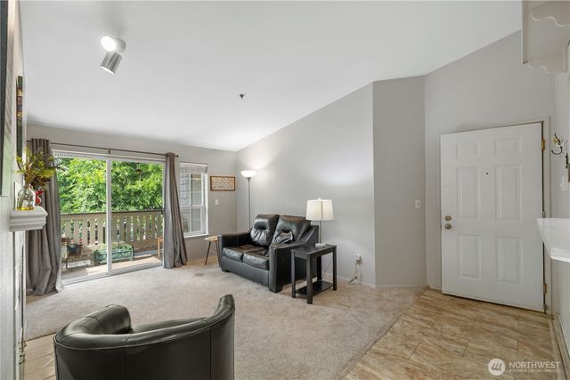 a living room with furniture and a floor to ceiling window