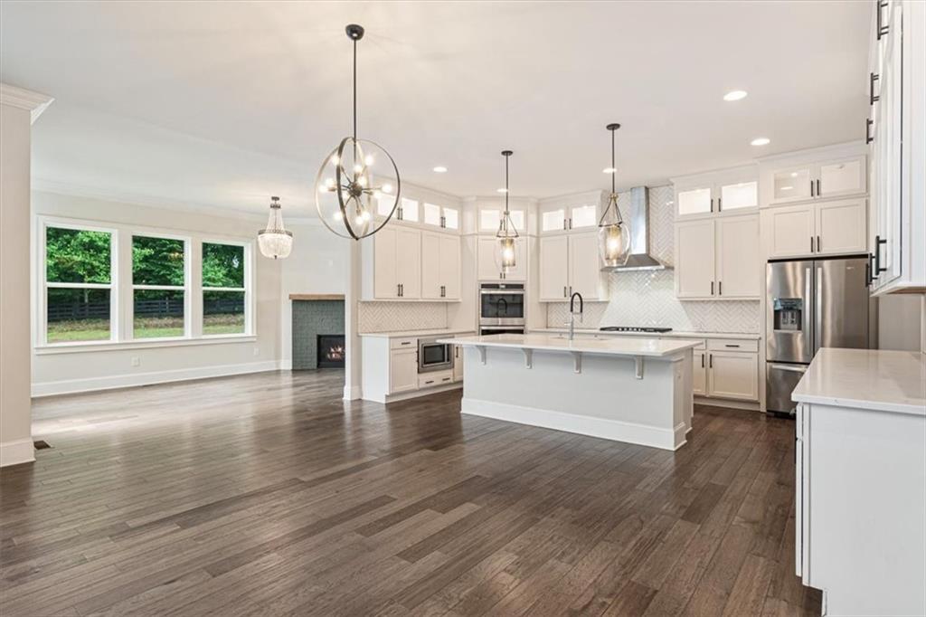 947 Hunter Way Milton, GA 30004 - Photo 28 of 78 a large white kitchen with lots of counter space wooden cabinets and appliances