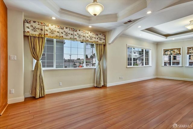 a view of a kitchen with furniture and wooden floor