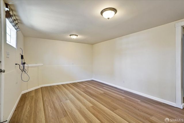 a view of a room with wooden floor and windows