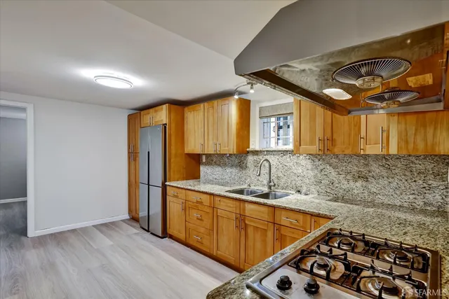 a kitchen with stainless steel appliances granite countertop a sink and a cabinets