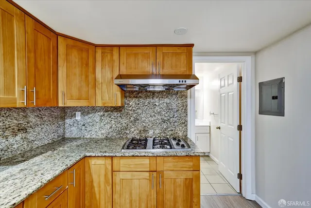a bathroom with a granite countertop sink and a bathtub