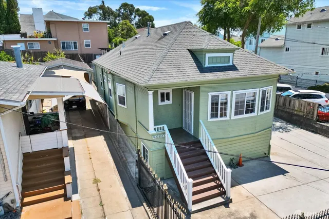 an aerial view of a house with a yard