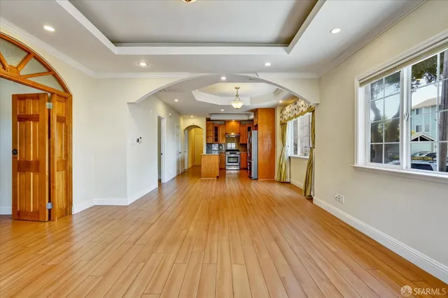 a big room with wooden floor and windows