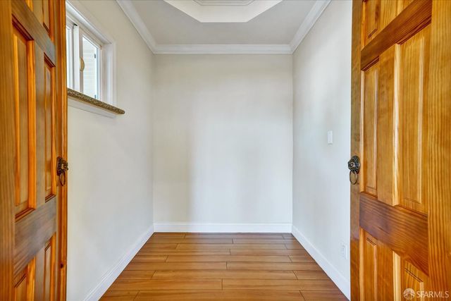 a view of a hallway with wooden floor and staircase