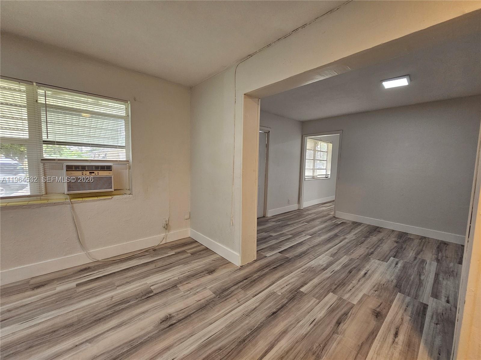 1727 Fletcher Street, Unit 1 Hollywood, FL 33020 - Photo 15 of 31 a view of wooden floor and windows in a room